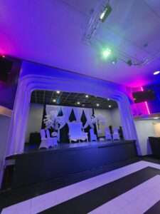 a throne kept at the stage area of royal palace lounge