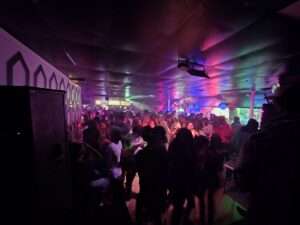 Packed dance floor with colorful lights and a lively crowd at a cocktail bar Akron Ohio during a weekend nightlife event.