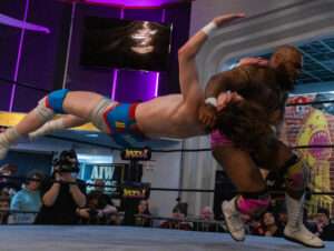 Powerful mid-air move during live wrestling events at Royal Palace Akron