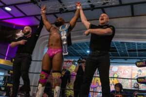 Champion celebrates victory during live wrestling events at Royal Palace Akron
