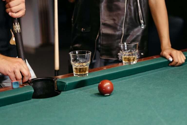 A bar with billiards featuring pool tables, comfortable seating, and a relaxed atmosphere where friends enjoy games and drinks together.
