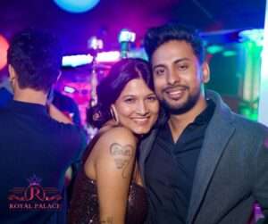 Couple smiling together on the dance floor at Bollywood Night in Akron Ohio at Royal Palace.