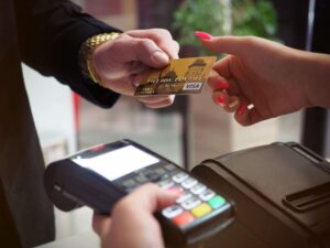 Guest paying with a card, representing affordable bridal shower venue booking
