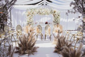 Elegant floral arch and seating setup at a bridal shower and wedding event space