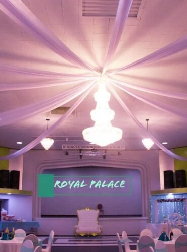 Elegant bridal shower hall interior at Royal Palace Akron with chandelier and draped ceiling