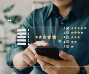 Person using smartphone reviewing event venue in Akron with star ratings and customer feedback interface